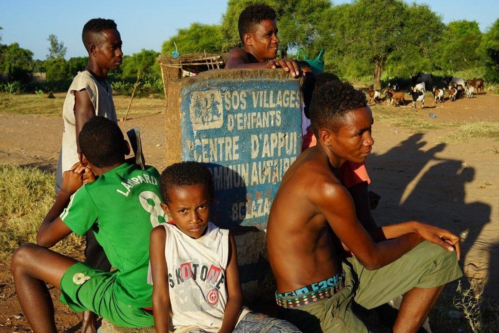Children and teenagers by the SOS Children's Villages sign, Madagascar